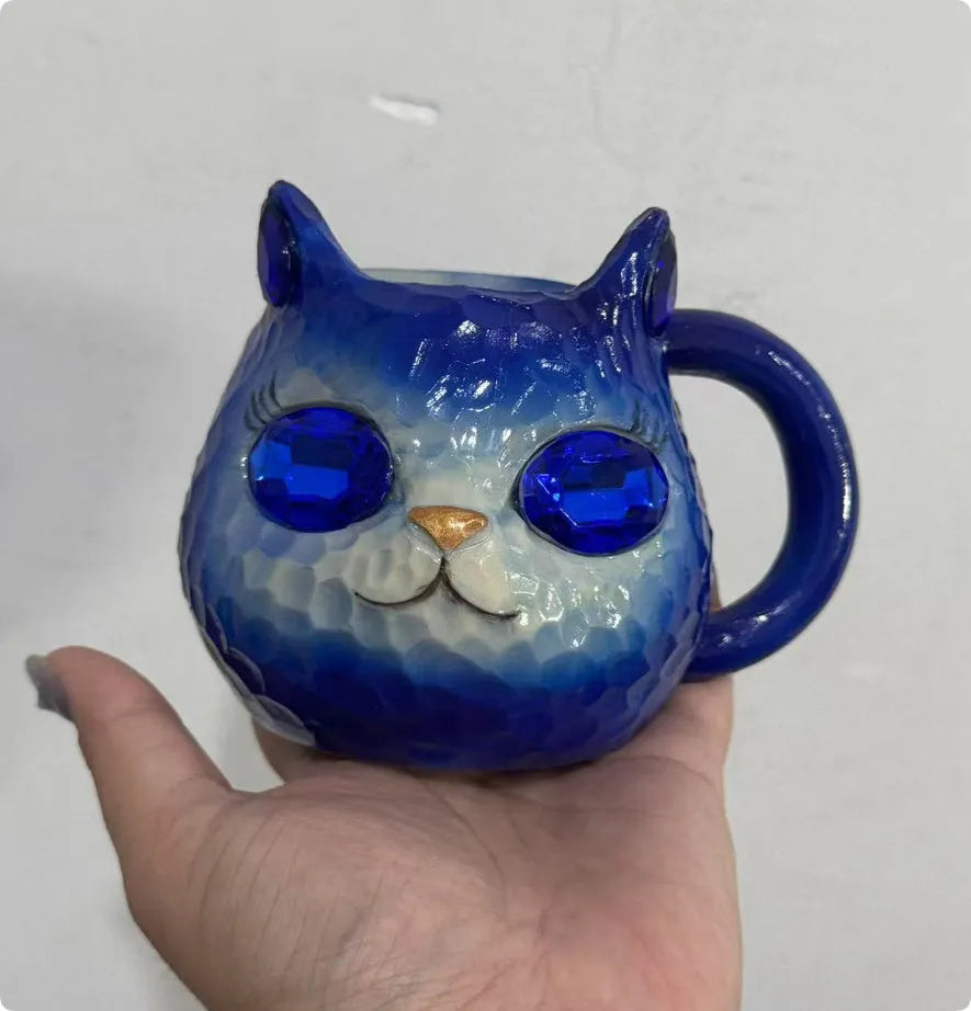 Clear resin Cat Cup ornament in purple, green, blue, and pink colour options on display.