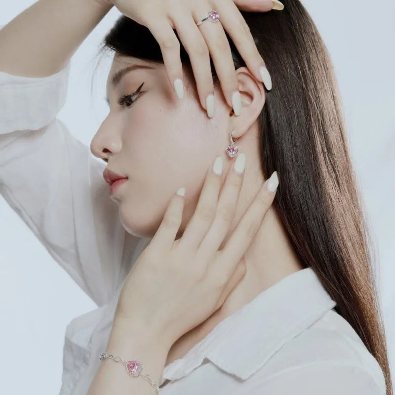 S925 sterling silver heart shaped earrings for women in pink electroplated finish on white background
