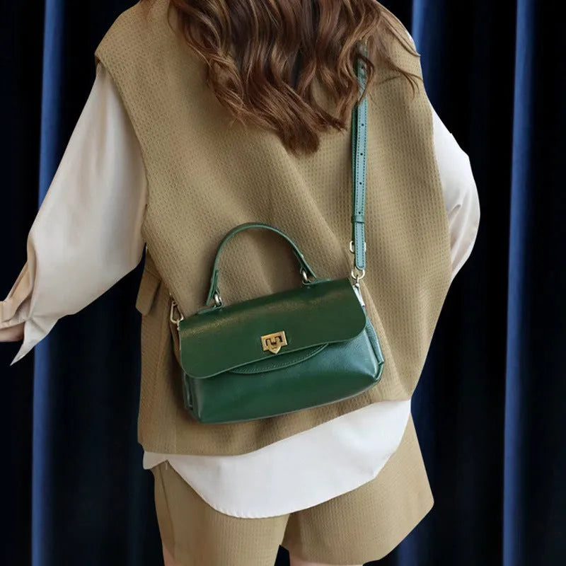 Dark brown women's saddleback leather handbag with double straps and an open front pocket.