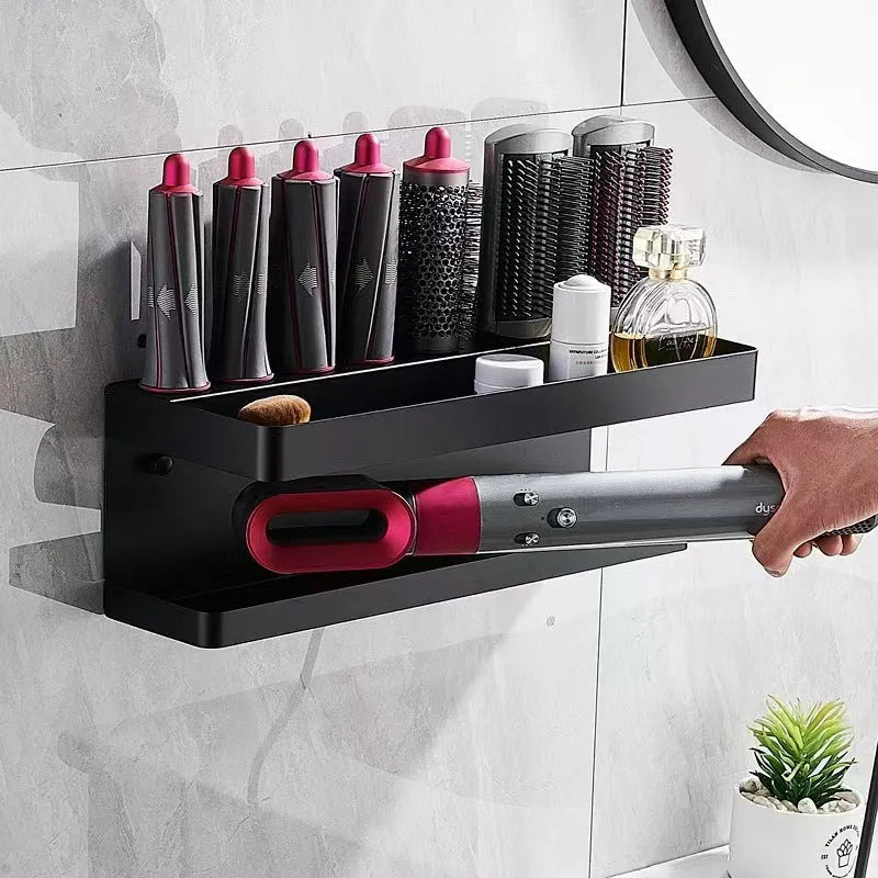 White double-layer aluminium wall rack holding hair curlers, mounted punch-free on a tiled bathroom wall.