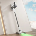 Light gray household wireless handheld folding tube vacuum cleaner with lighting function on a flat surface