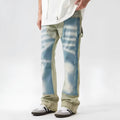 Yellow and blue retro patchwork jeans with splash-ink damaged design and zip fly.