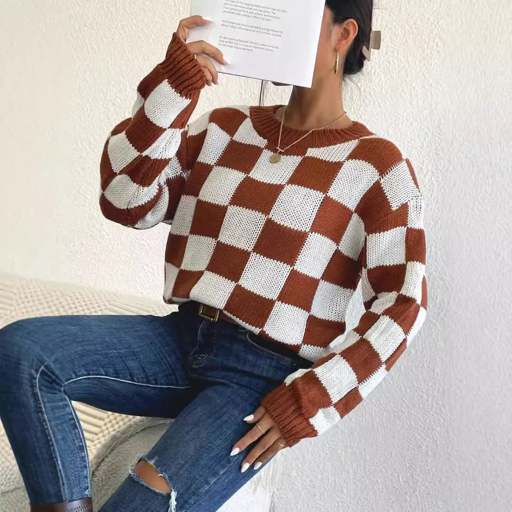 Dark brown plaid pattern on a loose round neck acrylic pullover sweater with long sleeves.
