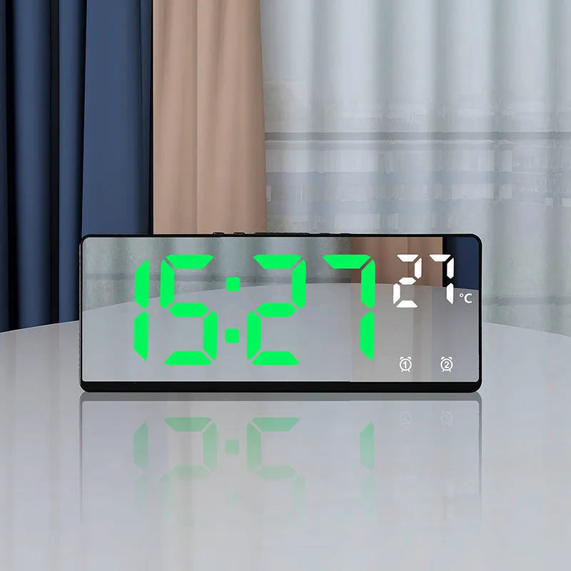 Electronic alarm clock with large LED screen showing time and temperature, in acrylic casing.