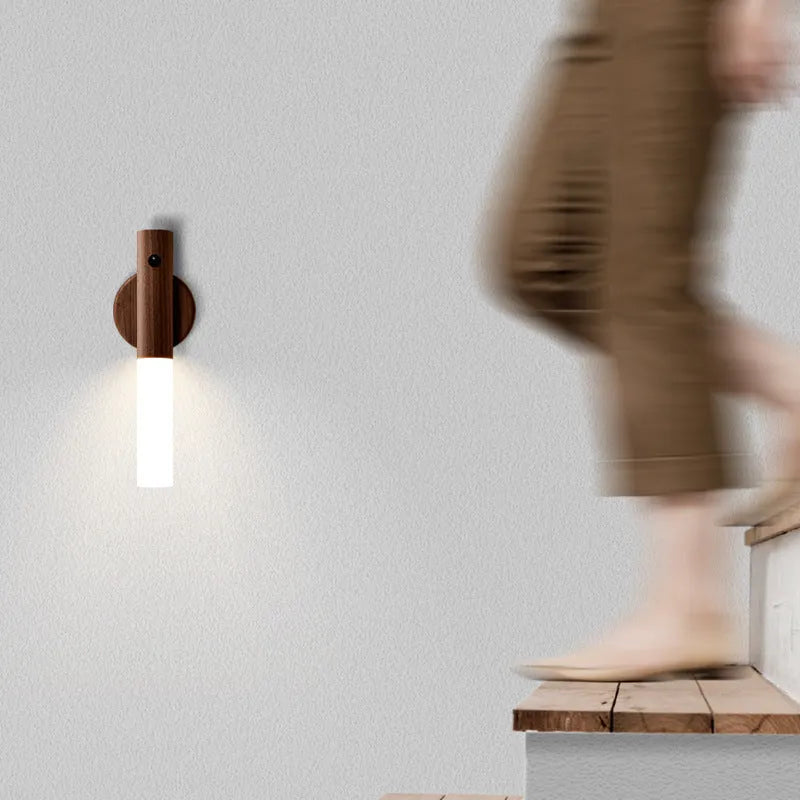 Smart sensor LED desk lamp in solid wood and acrylic, showing compact design beside a charging cable.
