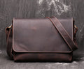 Vintage brown cowhide men's messenger bag showing front flap and adjustable shoulder strap