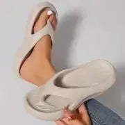 Women's black flip-flops with a thick textured sole and non-slip pattern.