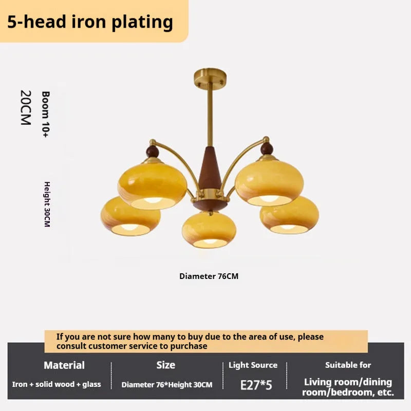 American retro persimmon chandelier with amber yellow glass shades in a dining room setting