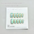 Electroplated Cat's Eye false nails in short ladder style on a hand, showing Aurora and solid colour designs.