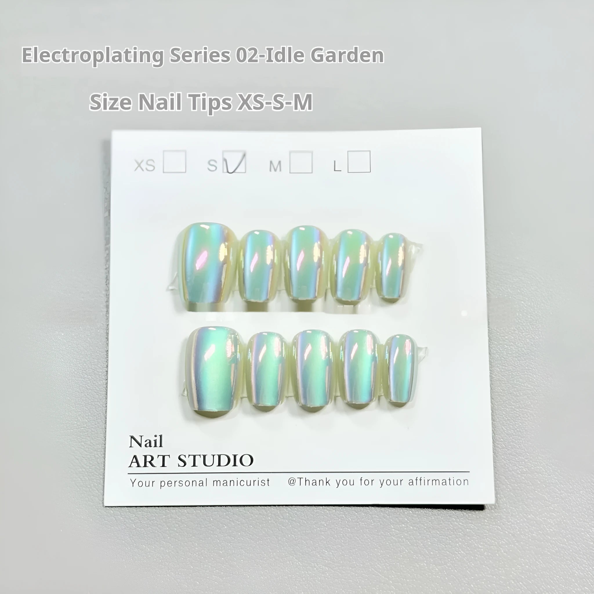 Electroplated Cat's Eye false nails in short ladder style on a hand, showing Aurora and solid colour designs.