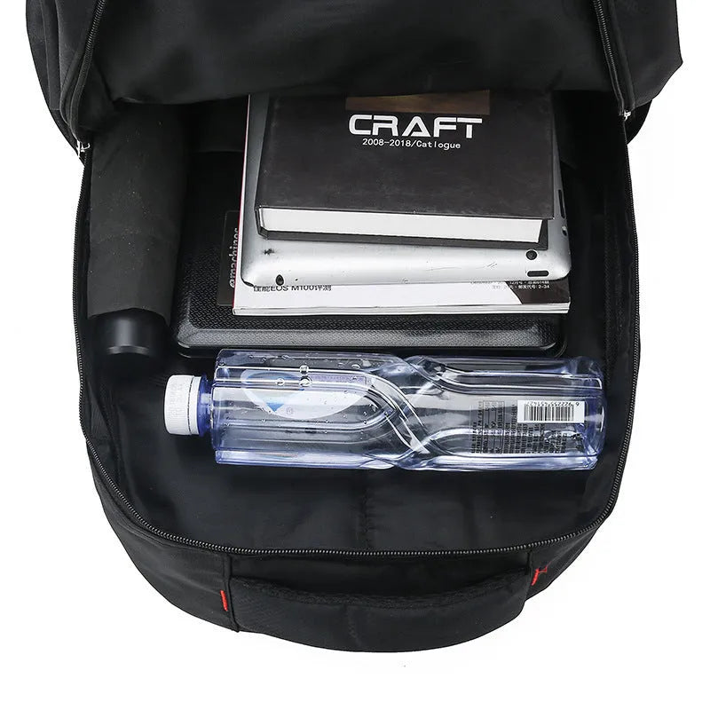 Large black nylon backpack with curved shoulder straps, shown open to display its polyester lining.