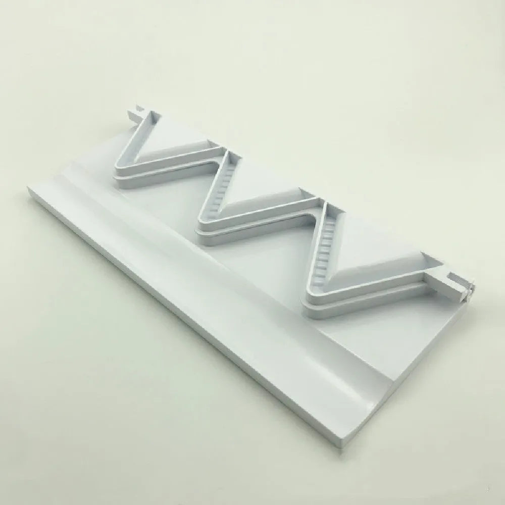 Pure white plastic dumpling maker 28.5 cm long on a kitchen countertop