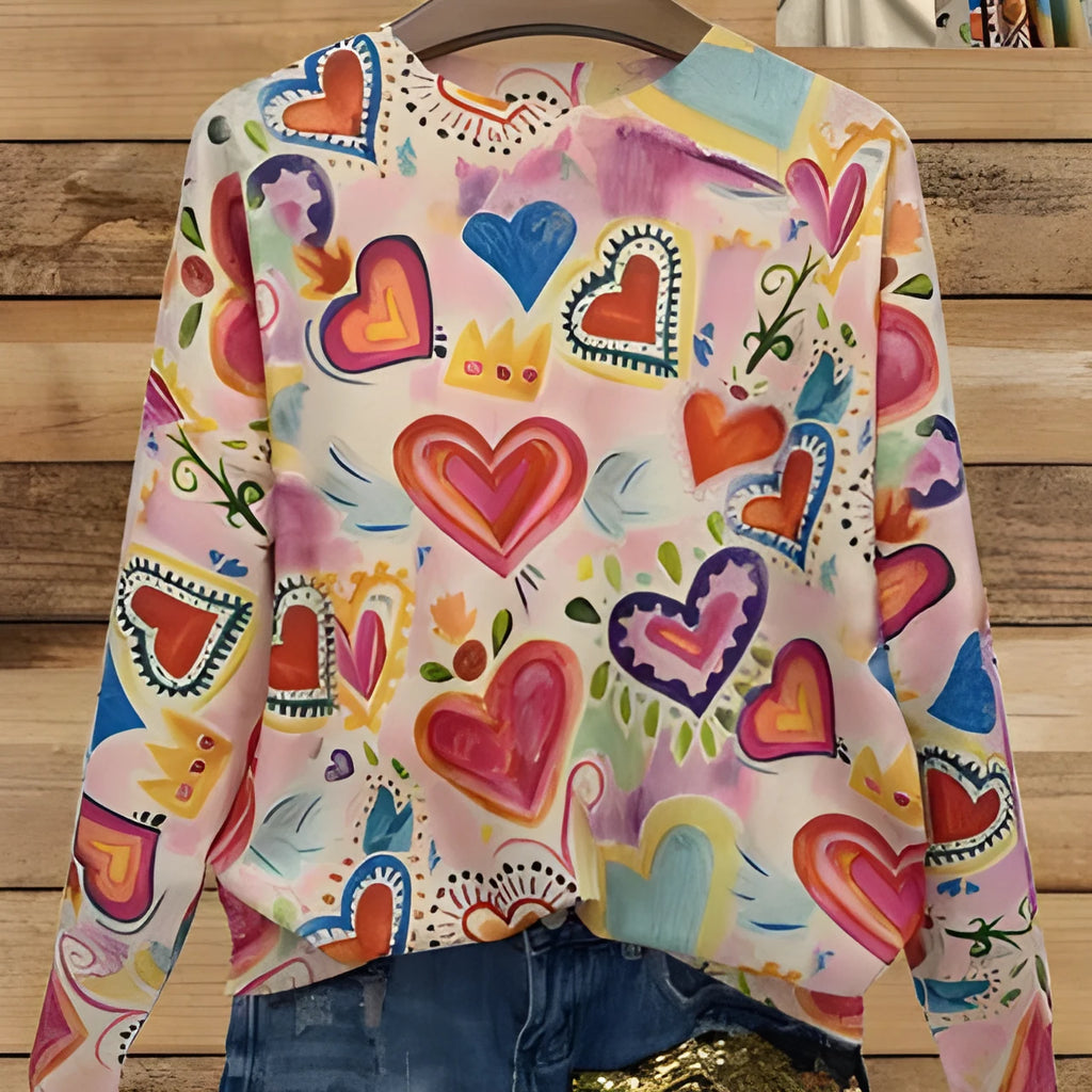 Loose fit digital printed top with lapel collar on a hanger, showing a graphic design.