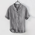 Retro-style linen pullover top in a solid colour with short sleeves, shown on a hanger.