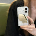 Solid colour iPhone case with a water ripple texture and a reflective mirror back, shown in a beige colour option.