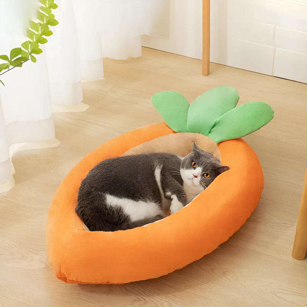 Carrot-shaped dog nesting bed with a soft, light-coloured blanket inside, suitable for a small dog.