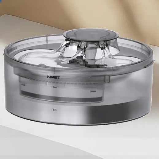 Automatic circulating water dispenser for cats and dogs with filter and pump on a kitchen floor.