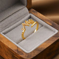 Gold geometric open fashion ring for women on a plain background