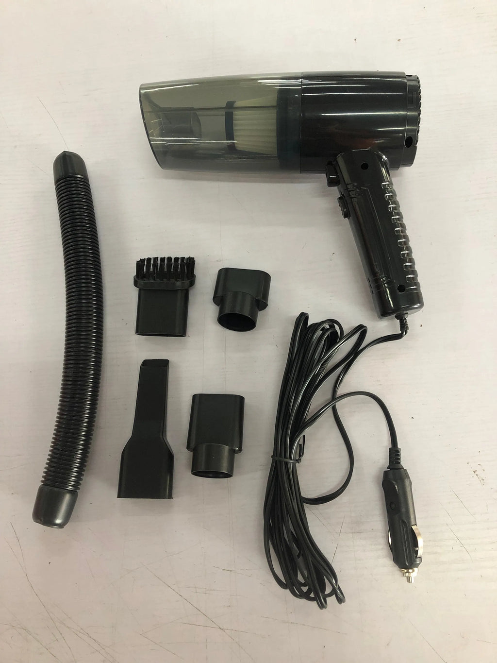 Starry sky black car vacuum cleaner with motor unit, long cord, and set of suction head accessories.