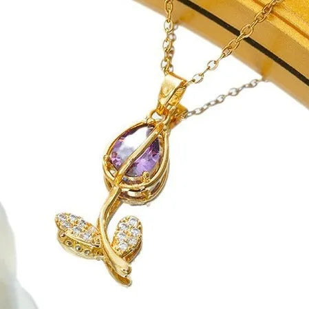 Zircon tulip flower pendant necklace on an adjustable titanium steel chain, shown in a gold colour.