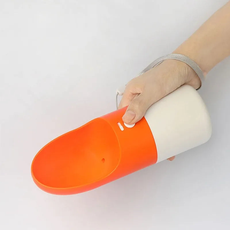 White MOESTAR rocket-shaped pet drinking cup with grey or orange accents showing one-button lock
