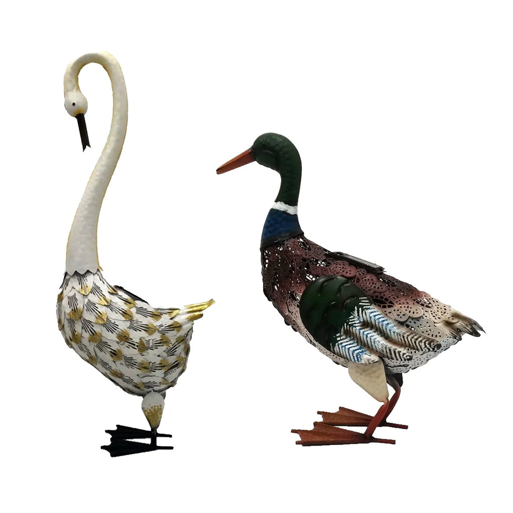 Wrought iron swan solar garden light with warm white LED on a lawn