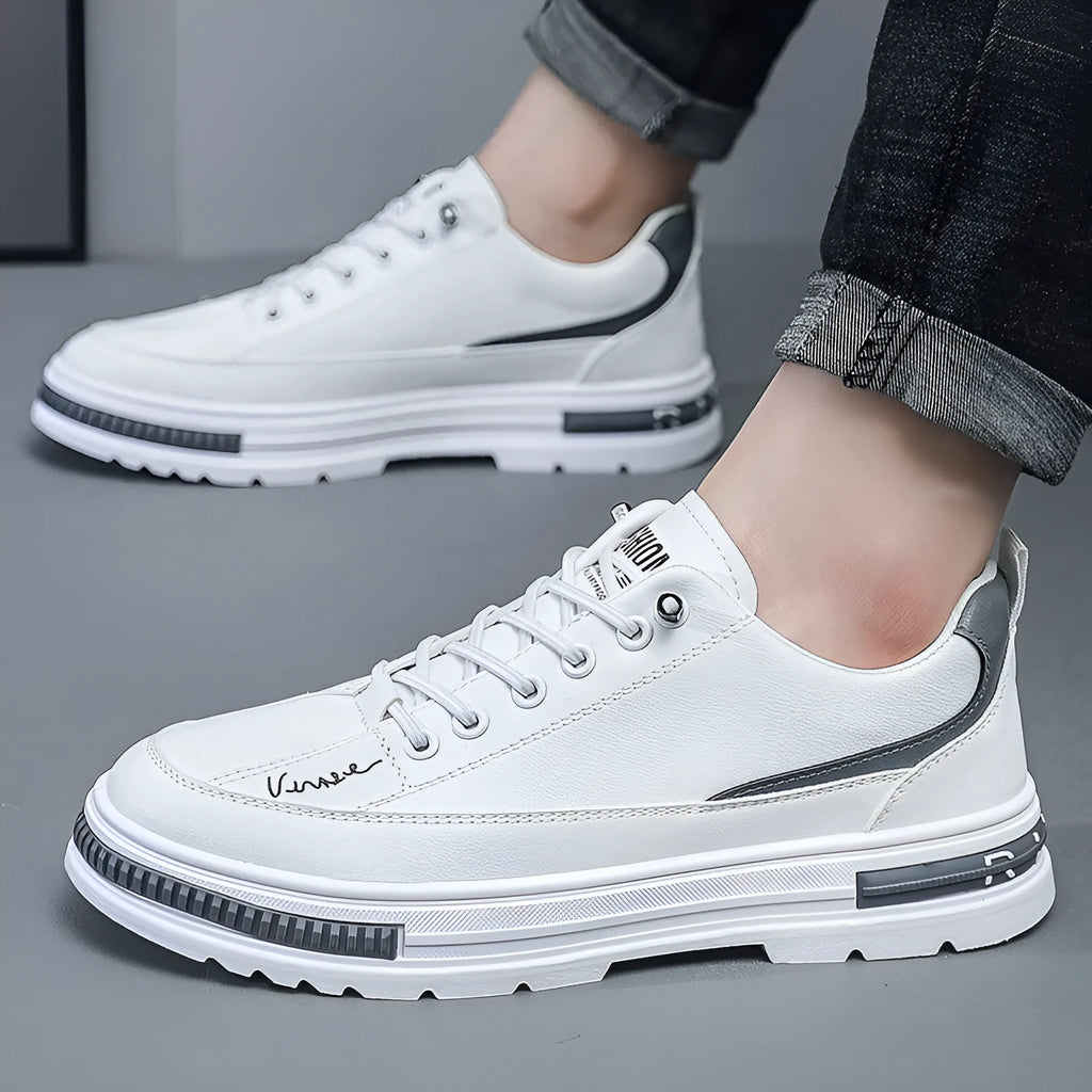 Men's white low-top platform sneakers with round toe and elastic band design on a plain background.