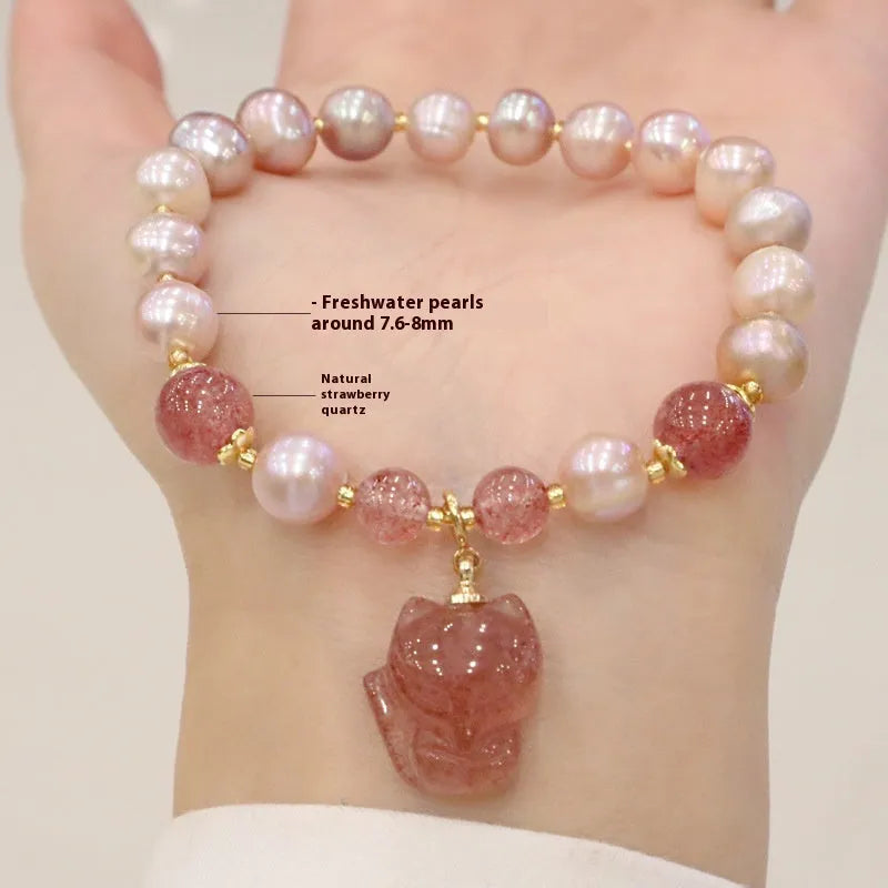 Light pink freshwater pearl bracelet with silver fox charm and strawberry quartz detail on adjustable strand