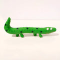 Green cartoon lizard-shaped dog chew toy with textured surface for teeth cleaning.