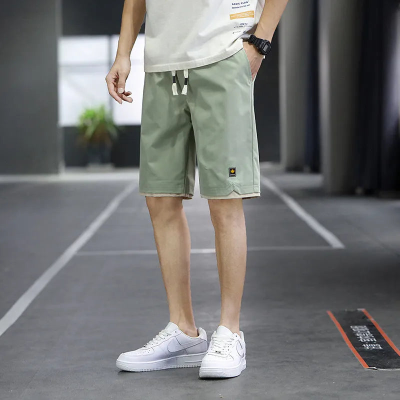 Korean-style loose-fit casual shorts in polyester with micro elasticity, shown in green colour