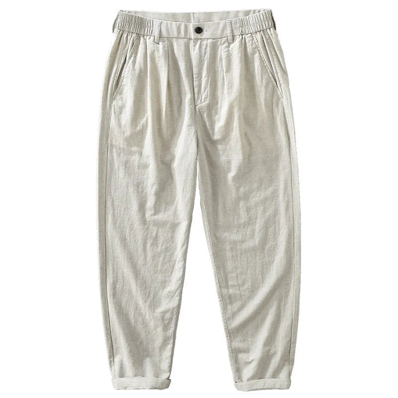 Man wearing loose straight-leg cotton linen trousers in a raw jute colour, showcasing the Japanese retro casual style.