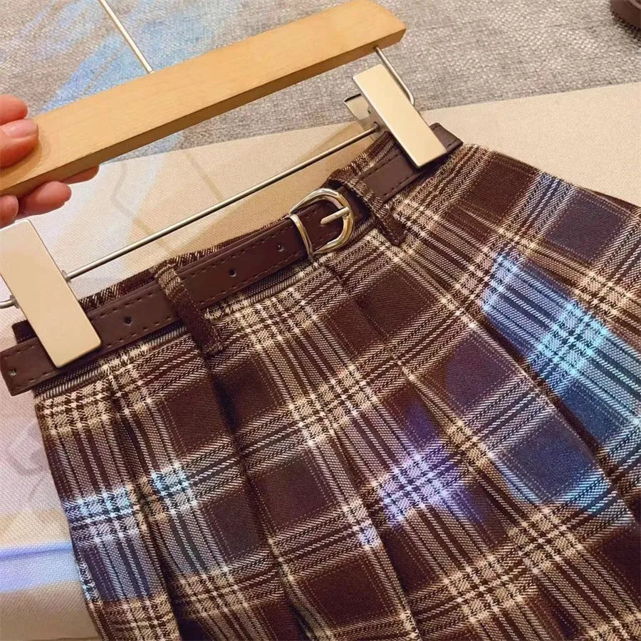 Girls red and black plaid A-line pleated skirt made from cotton blend fabric.