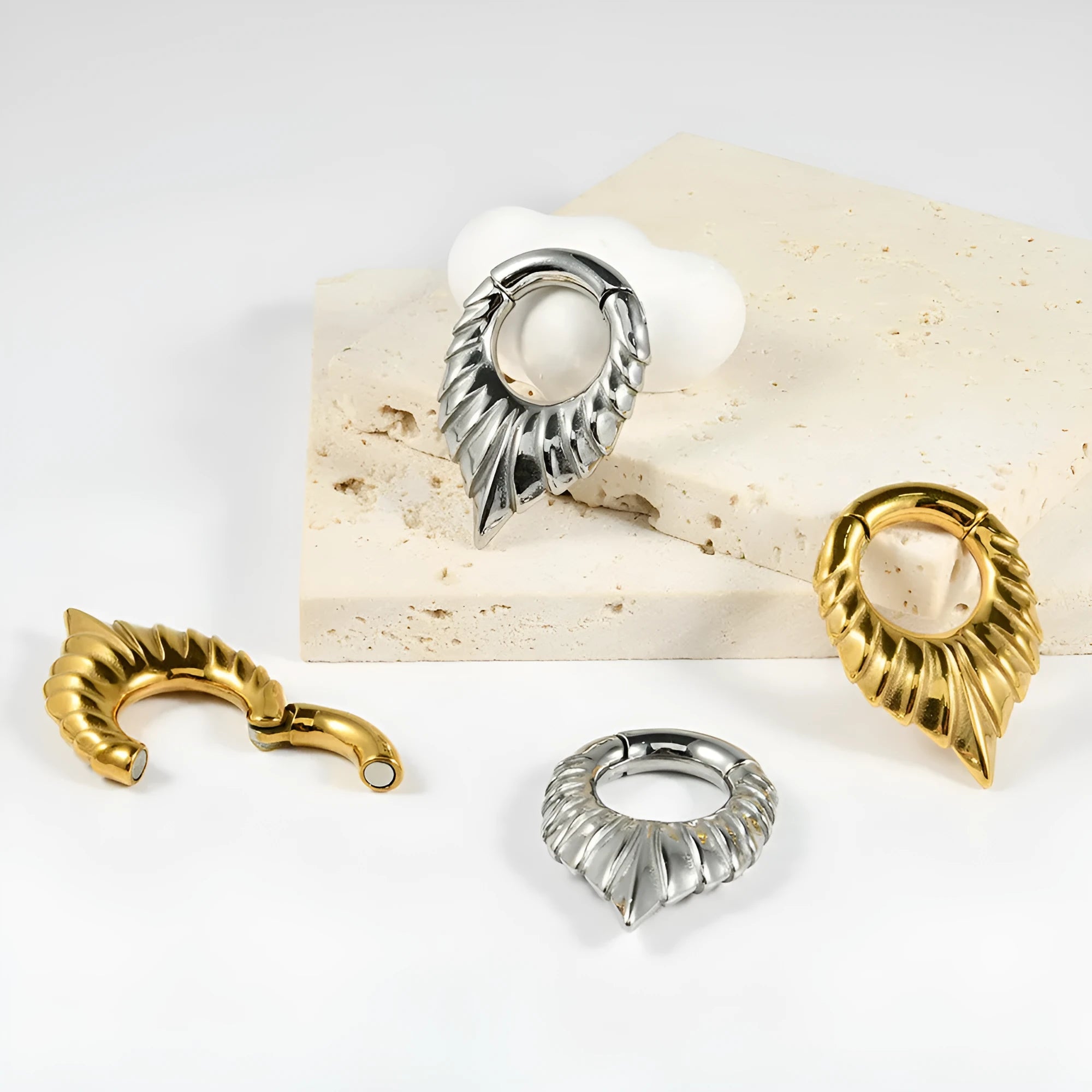 Stainless steel drop-shaped egg ear extender with totem engraving for auricle piercing.