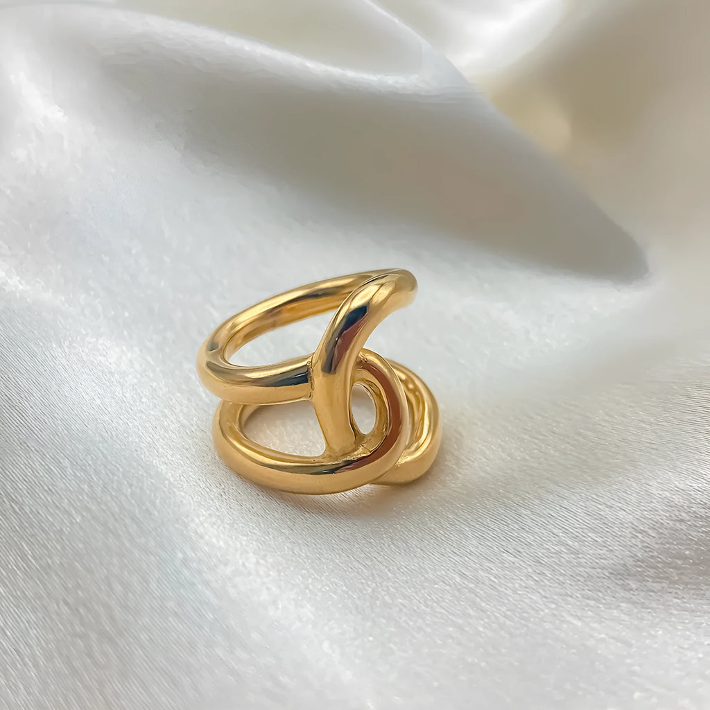 Adjustable knotted stainless steel ring for women in gold or steel colour, showing U-shaped geometric design.