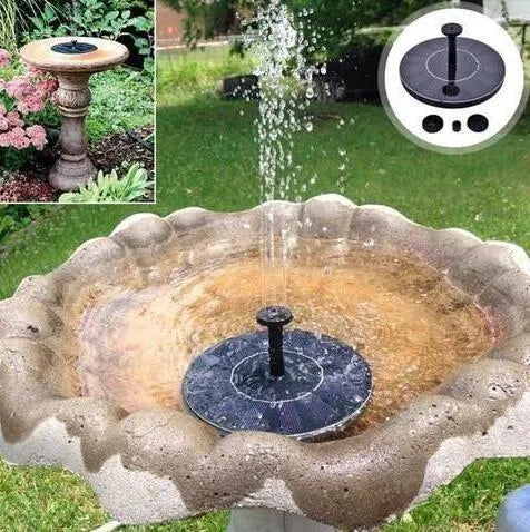 Black solar-powered water fountain pump with four spray nozzles, placed in a birdbath.