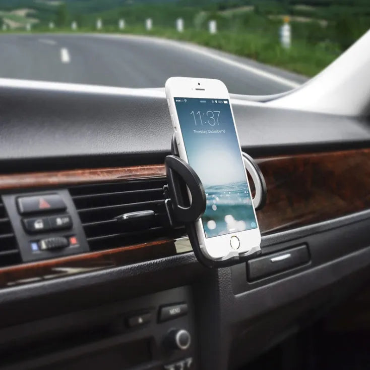 Black plastic car phone holder mounted on air conditioning vent holding smartphone