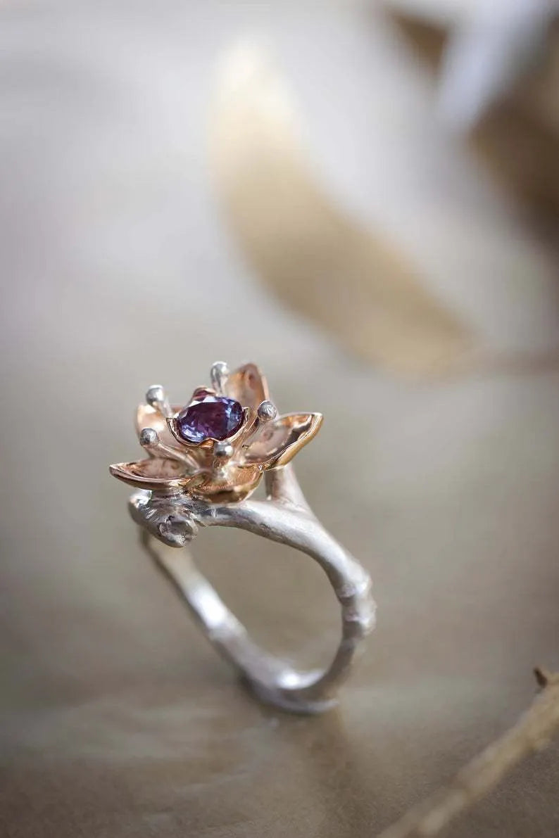 Silver two-tone geometric floral fashion ring for women on a hand.