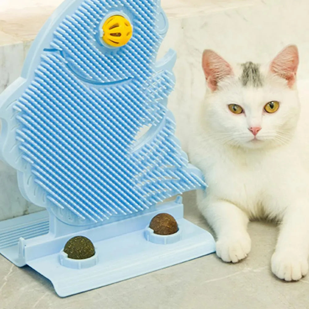 Blue plastic fish-shaped cat wall scratcher with brush, two green catnip balls, a bell, and a base.