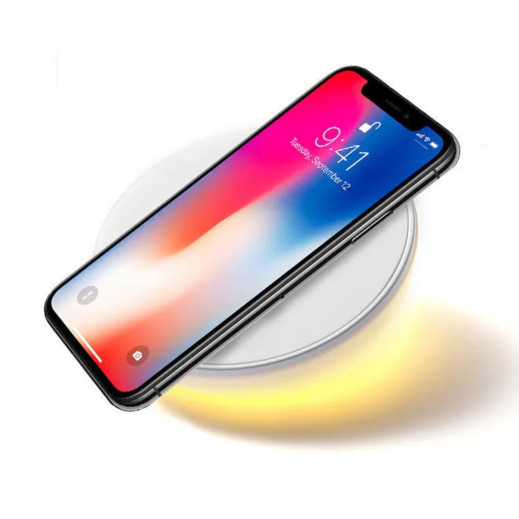 White wireless charging pad with digital clock display and control buttons for smartphone charging