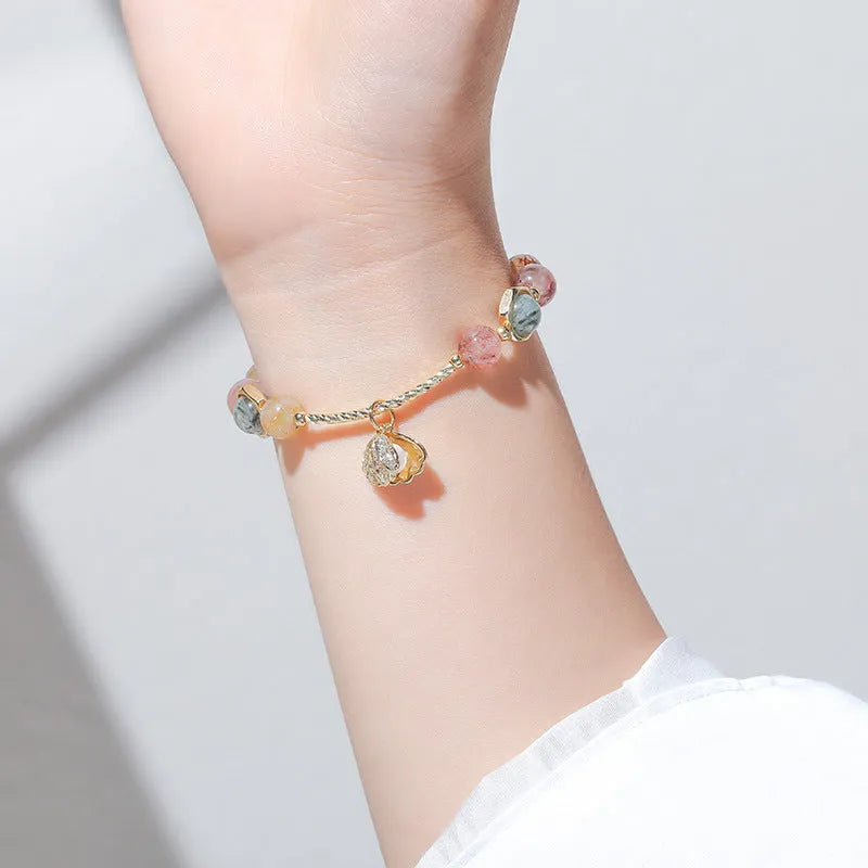 Women's crystal bracelet with coloured hair crystal shells and red sealant flower shells on wrist