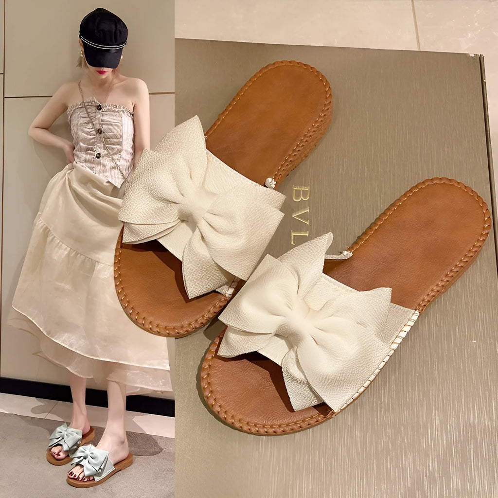 Women's beige suede sandals with bow detail and flat rubber soles