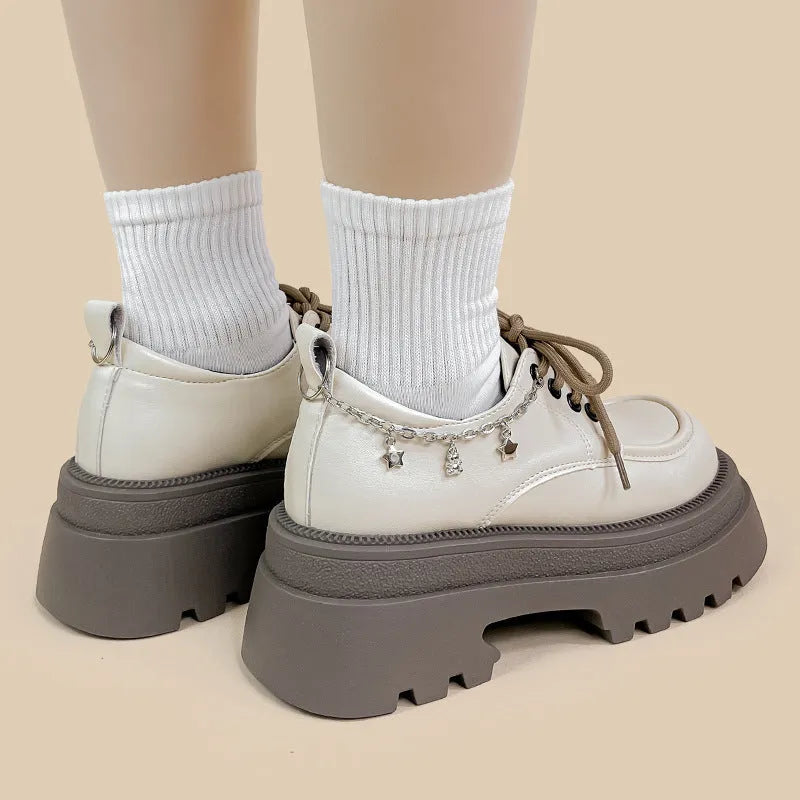 White platform Mary Jane shoes with chunky heel and front lace-up closure