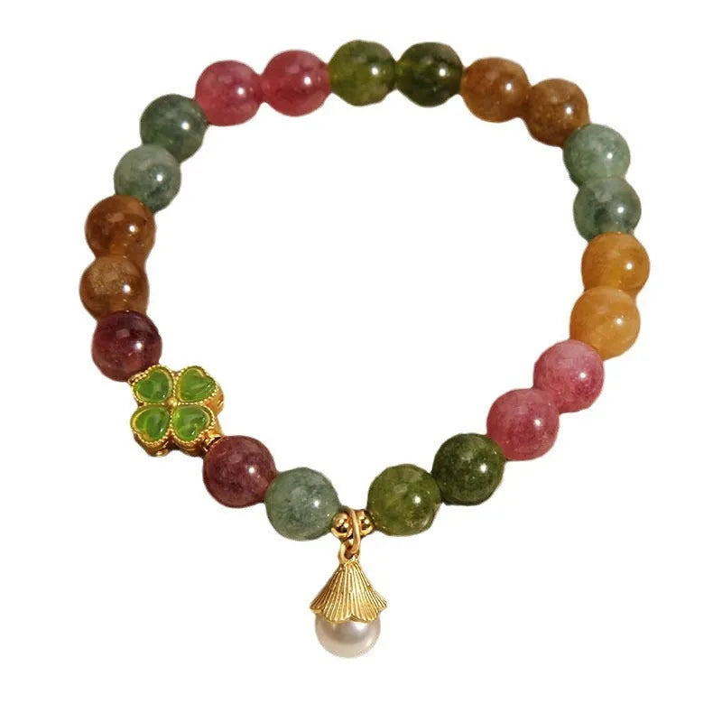Women's colourful tourmaline bracelet with four-leaf clover charm and pearl pendant on a mixed material electroplated chain.