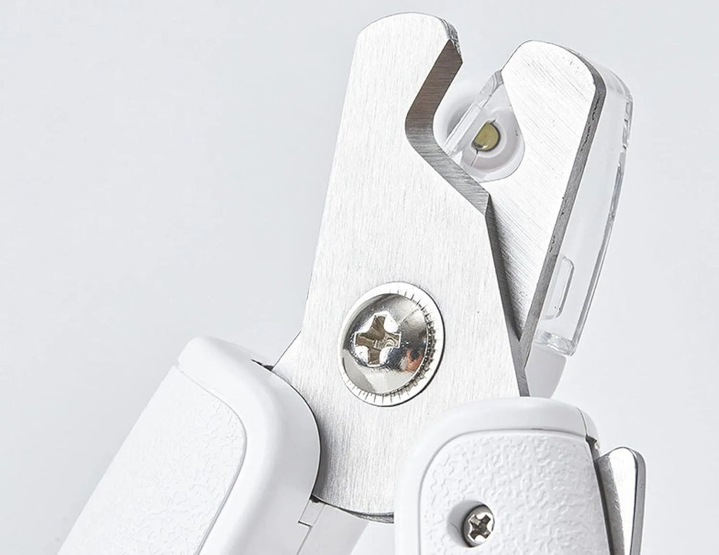 White pet nail clippers with LED light on the handle and a clear anti-splash guard covering the blades.