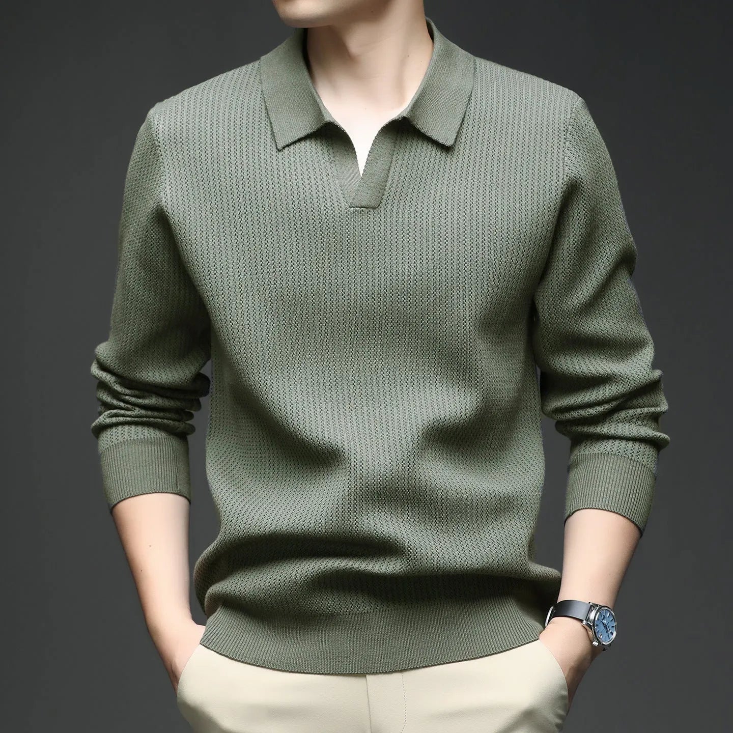Man wearing a loose green casual pullover sweater, showing the simple long-sleeve design.