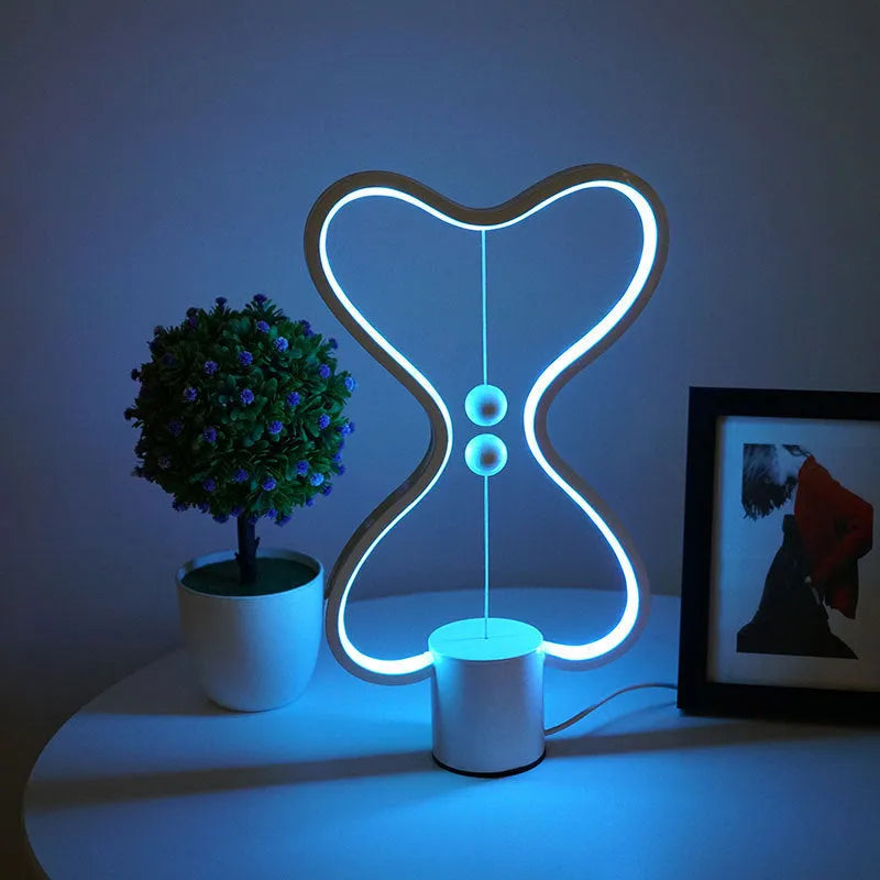 LED balance night lamp with 7 colour options, USB powered, showing suspended netball design