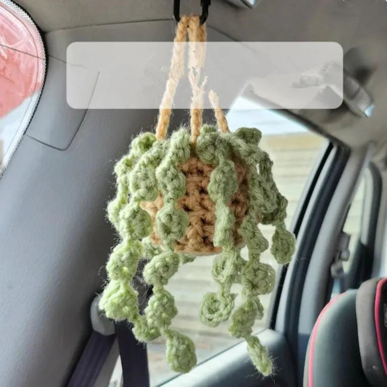 Green and white knitted wool car plant decoration with 8cm base and hanging rope.