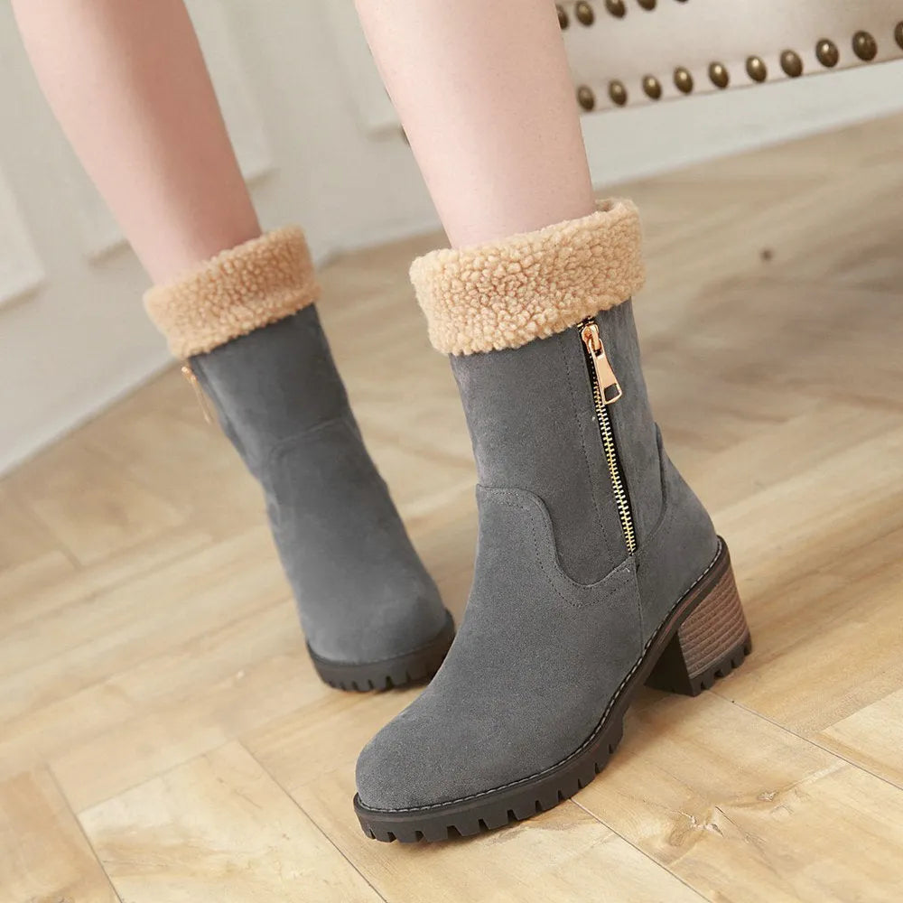 A pair of adult snow boots in black with a soft plush lining and rubber insole.