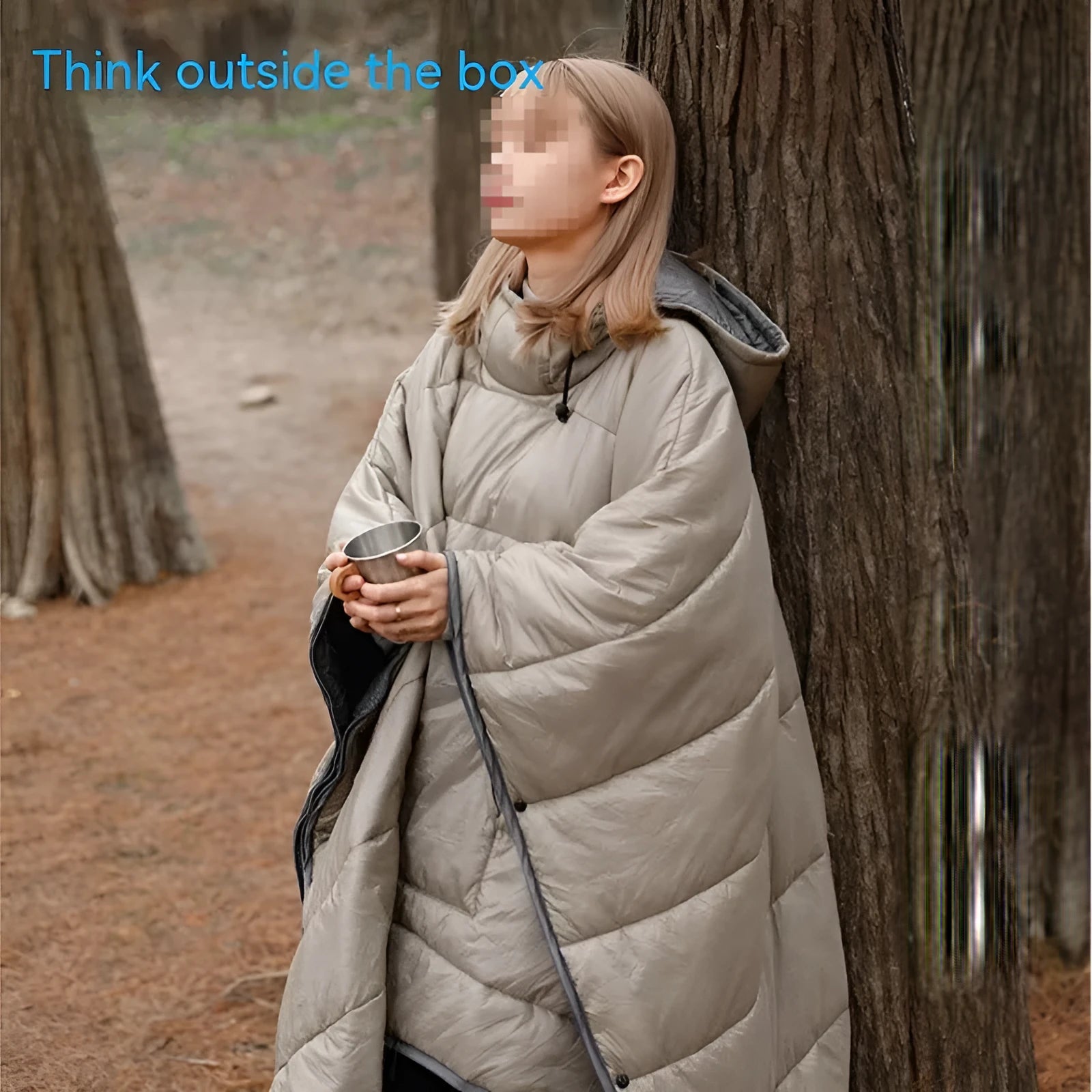 Outdoor wearable cloak sleeping bag in army green or grey, shown as a blanket and cape.