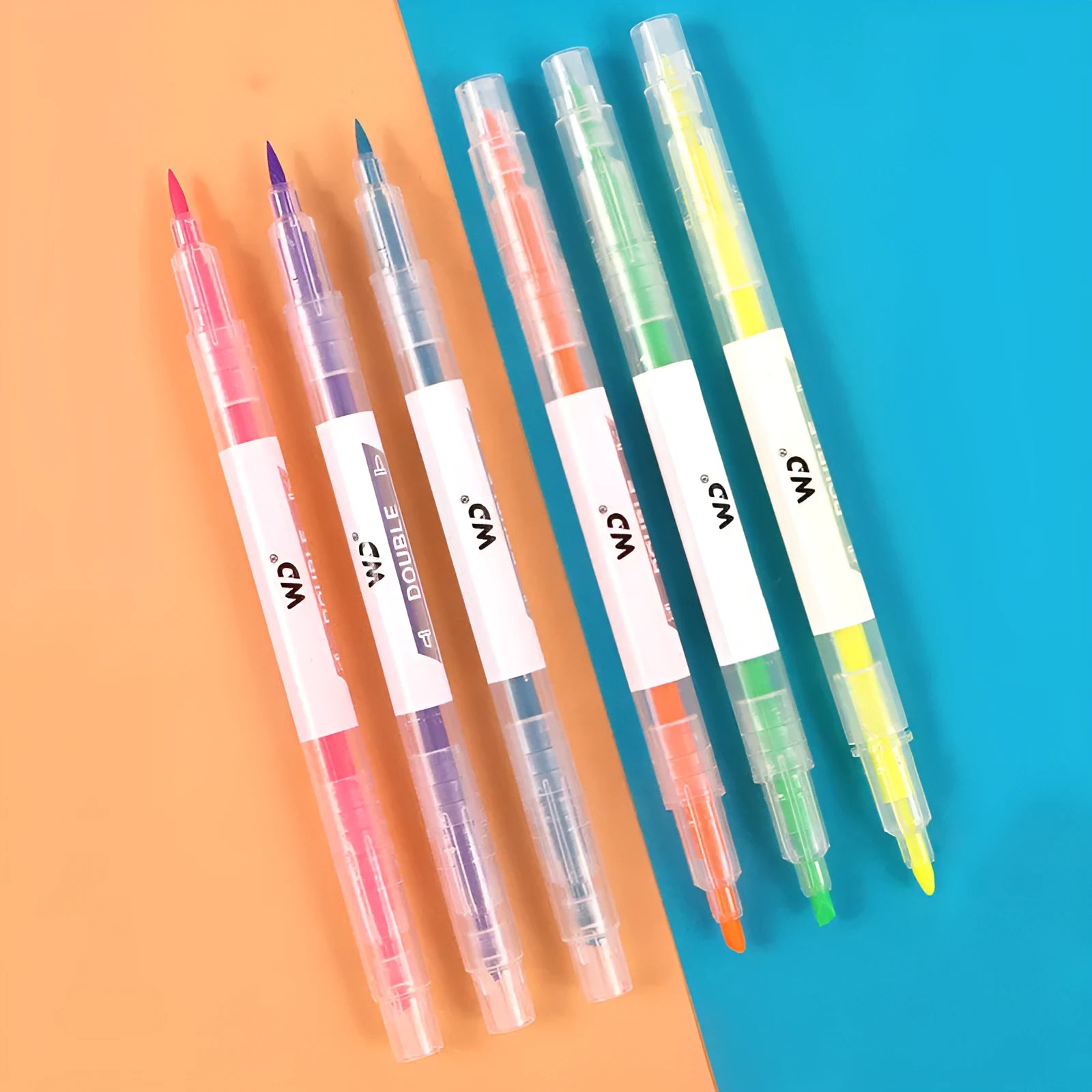 Six double-headed marker pens showing round and oblique nibs in assorted colours including orange, purple, yellow, green, blue, and pink